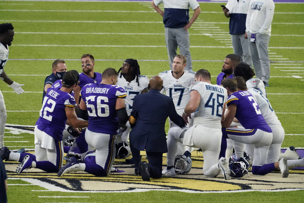 Tennessee Titans and the Minnesota Vikings players meet at midfield following an NFL football g ...