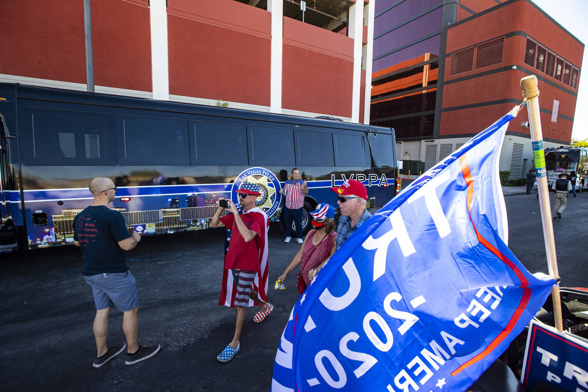 Jason Semerau, of Las Vegas, second from left, records with his phone as supporters of law enfo ...