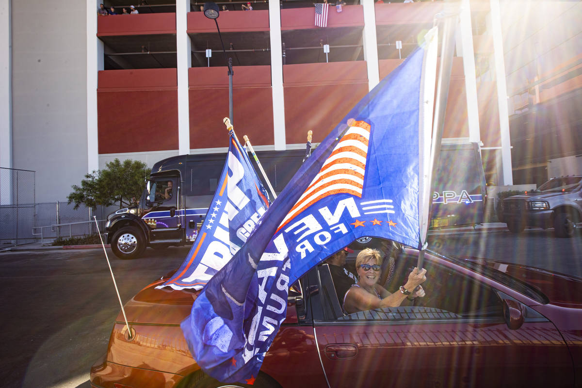 Lisa Schultz, of Las Vegas, waves a flag as supporters of law enforcement and President Donald ...