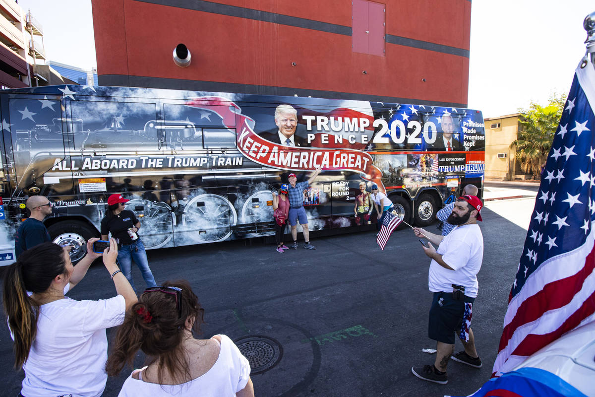 People take photos as supporters of law enforcement and President Donald Trump prepare for a pa ...