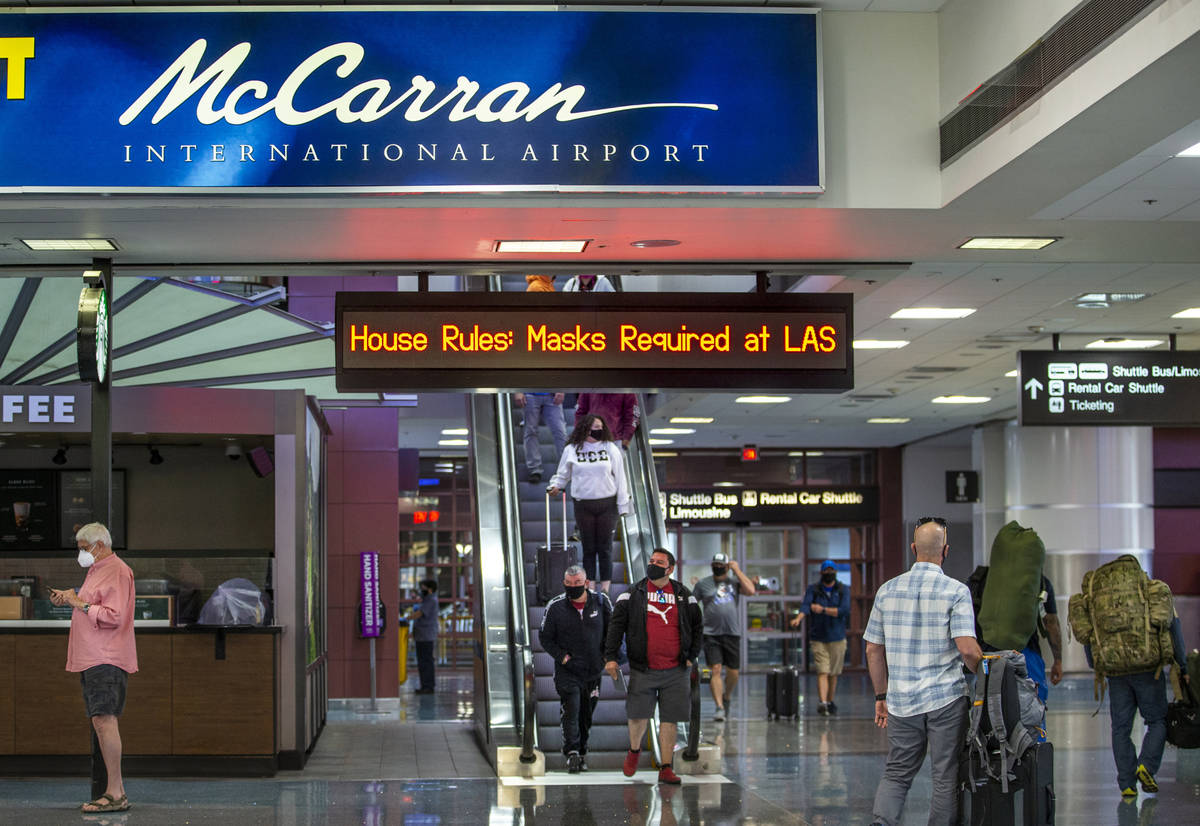 Passengers move about the Terminal 1 baggage claim area at McCarran International Airport on W ...