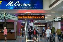 Passengers move about the Terminal 1 baggage claim area at McCarran International Airport on W ...