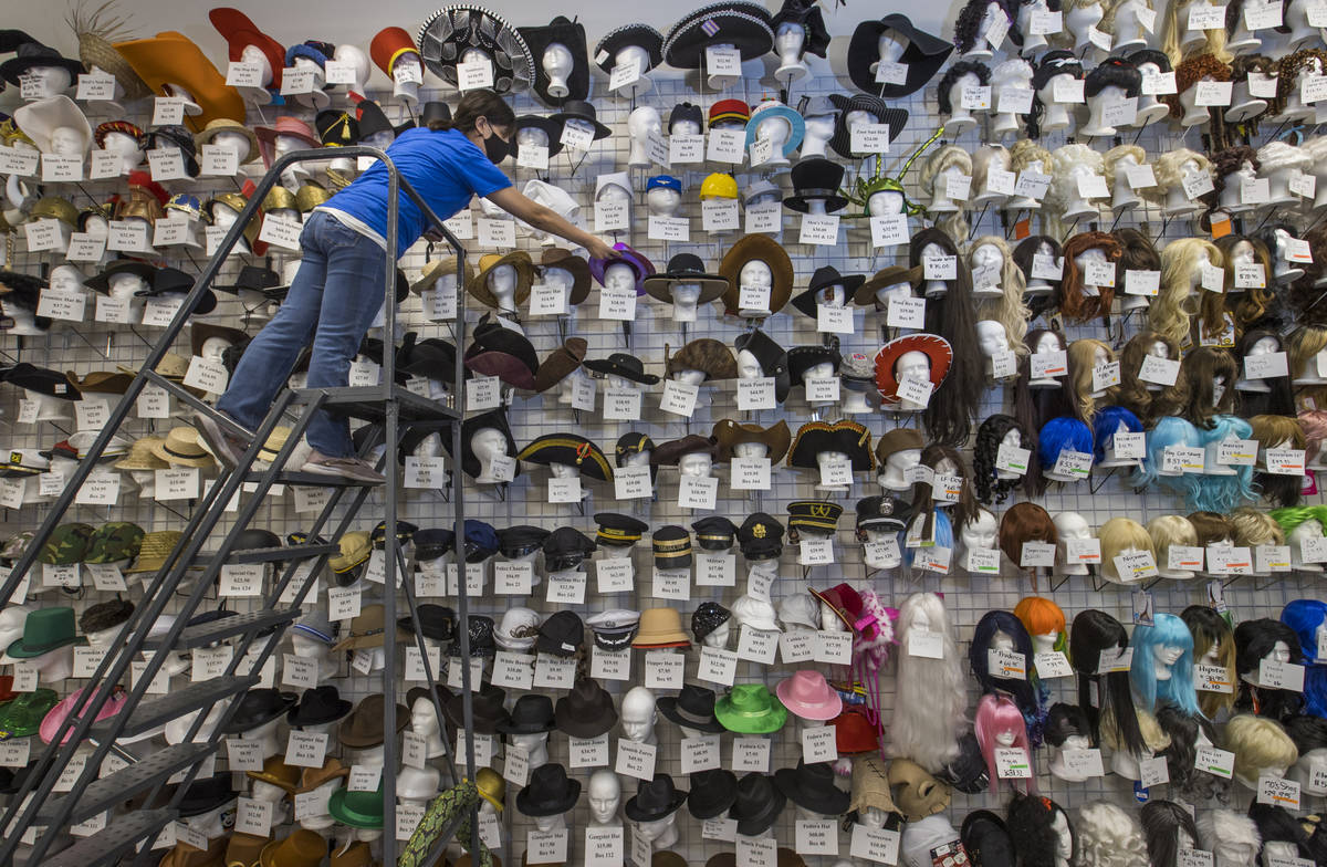 Sandra Zarco arranges some of the hats for sale at the Star Costume & Theatrical Supply on Satu ...