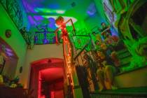 Tiffany and Leroy Garcia pose like ghosts with their sons in their entryway that is in the begi ...
