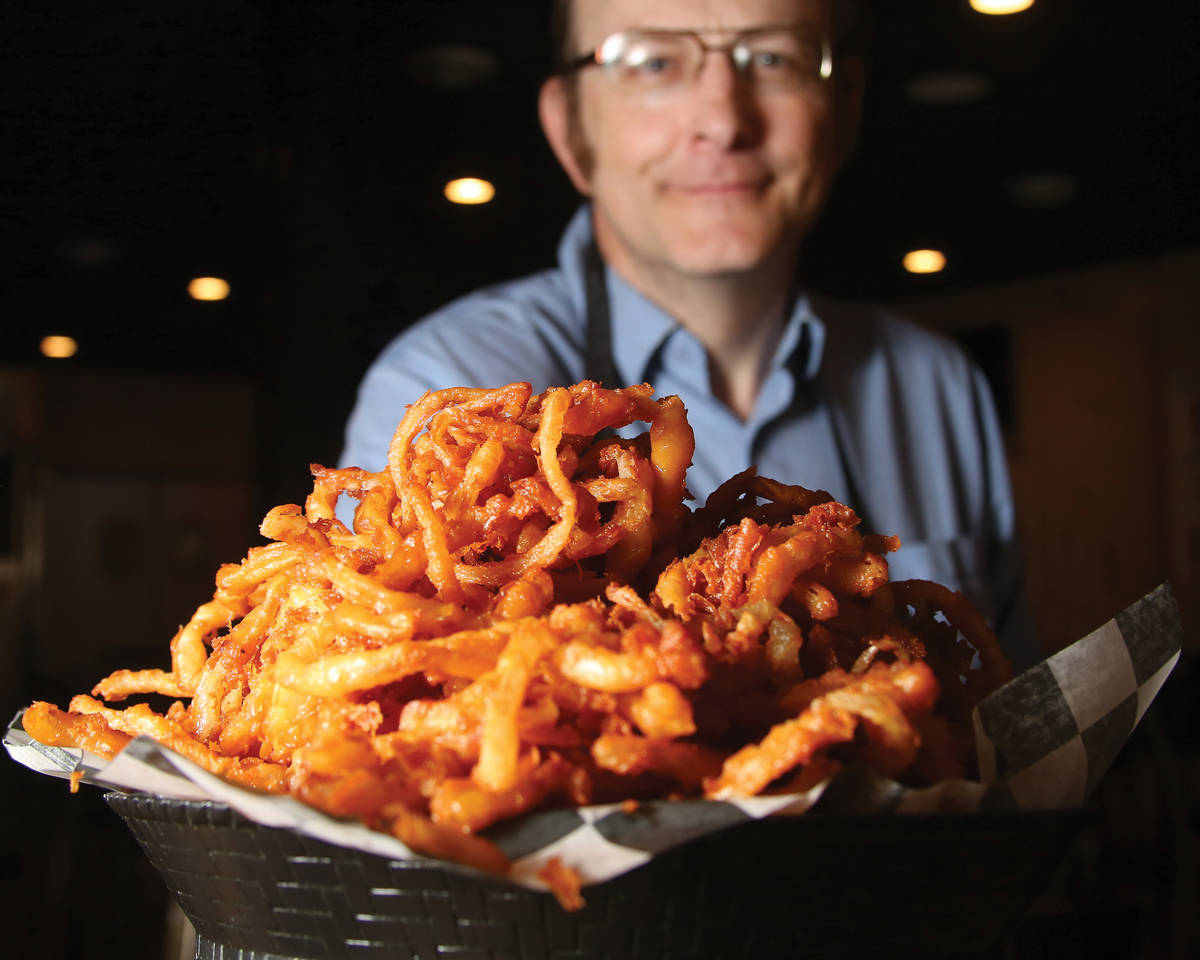 Larry Lang proudly holds up a plate of his onion rings. (Capp Bros. Productions)