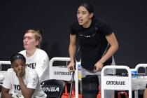 Las Vegas Aces forward Dearica Hamby, center, calls out words of encouragement from the bench a ...