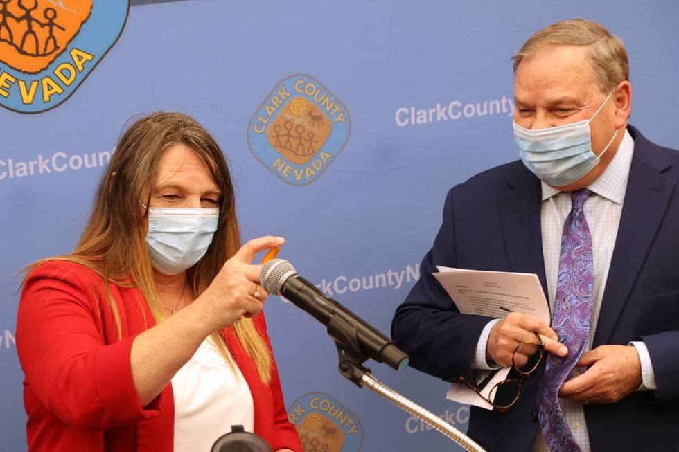 Clark County Commission Chairman Marilyn Kirkpatrick sanitizes the microphone as she and Dr. Mi ...
