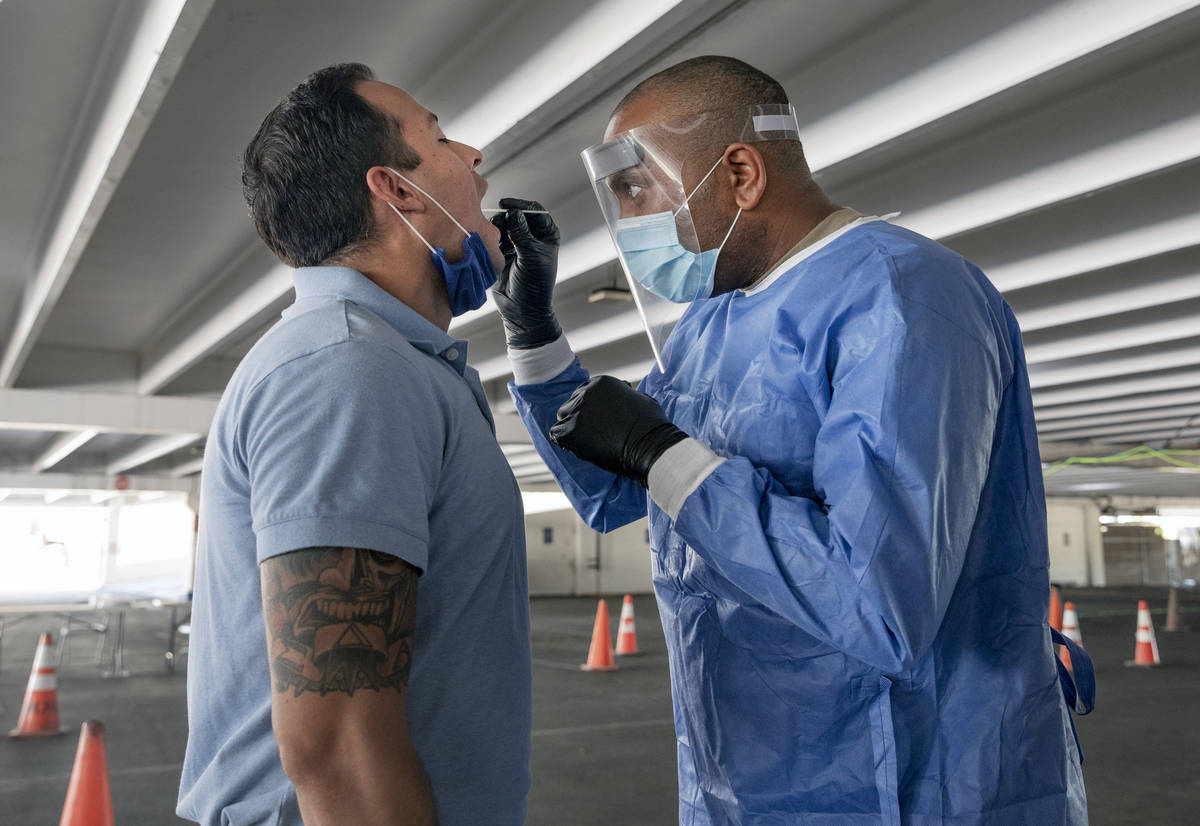 Clark County fireman Eddie Galaz, left, and combat medic Nevada National Guard Sgt. Steve Sanso ...