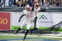 UNLV wide receiver Mekhi Stevenson (2) celebrates with teammate Jacob Gasser (82) after making ...