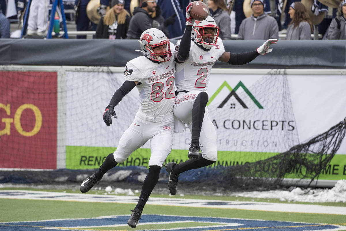 UNLV wide receiver Mekhi Stevenson (2) celebrates with teammate Jacob Gasser (82) after making ...