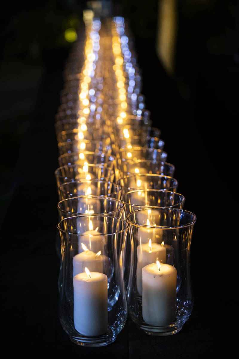 Candles are lit after the names of the victims of the Route 91 Harvest festival shooting were r ...