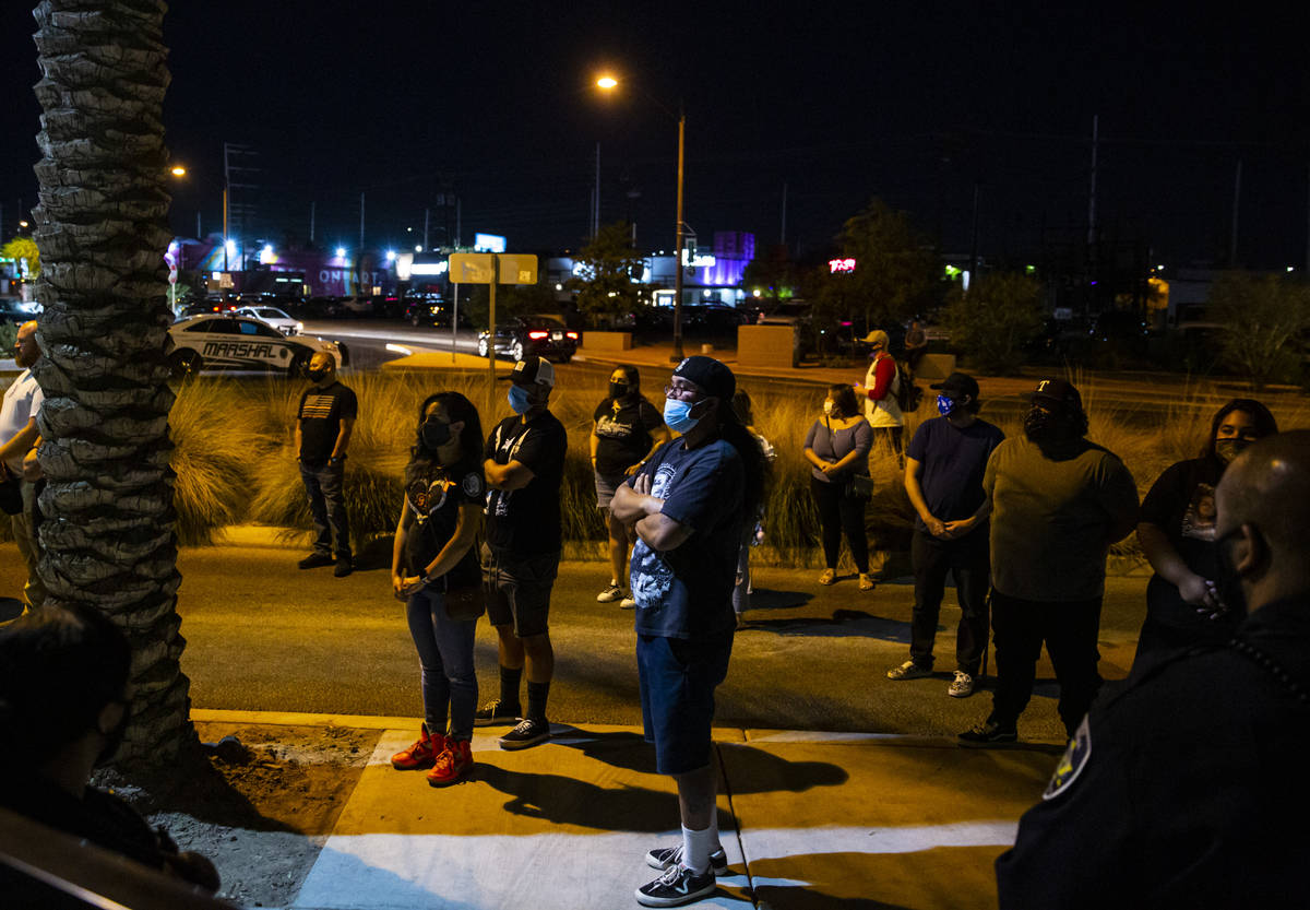 People watch as the names of the victims killed in the Route 91 Harvest festival shooting are r ...