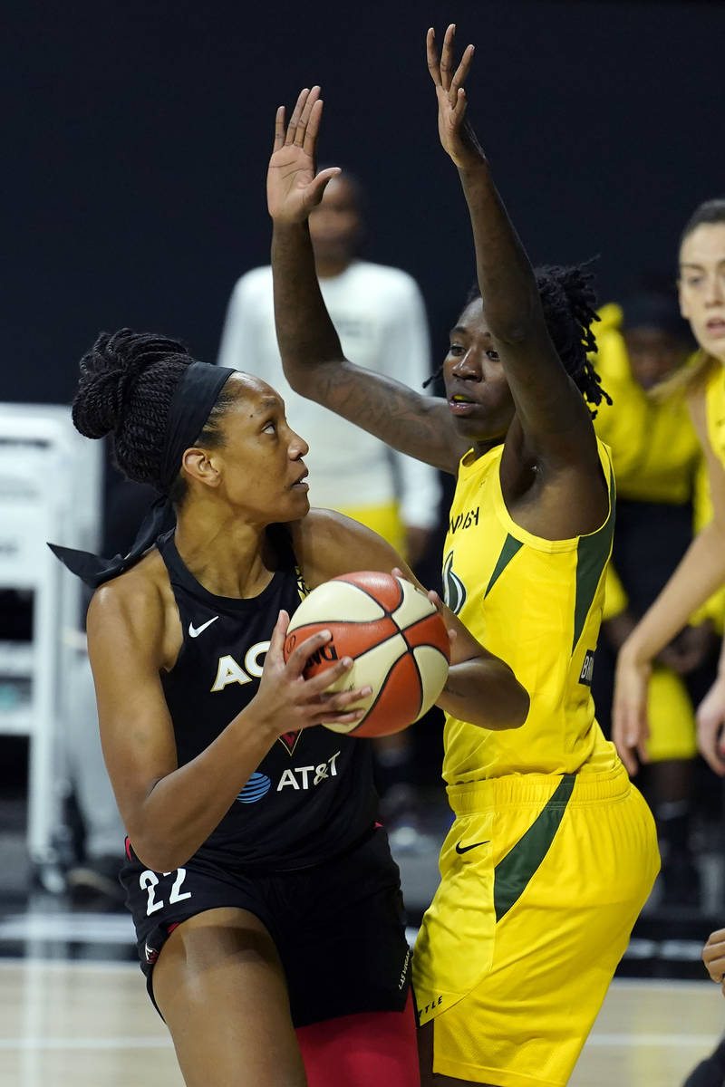 Las Vegas Aces center A'ja Wilson (22) goes up against Seattle Storm forward Natasha Howard (6) ...