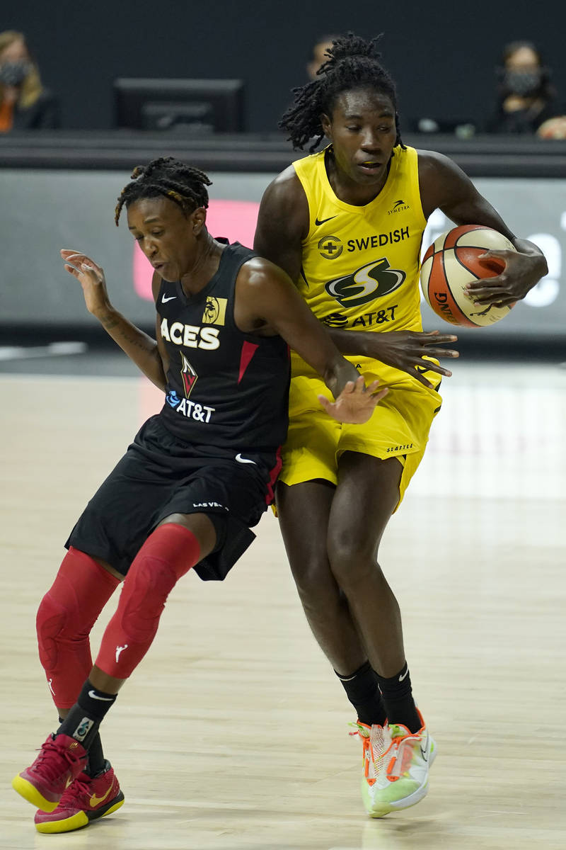Seattle Storm forward Natasha Howard (6) and Las Vegas Aces guard Danielle Robinson (3) collide ...
