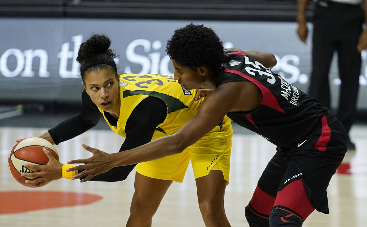 Seattle Storm forward Alysha Clark (32) looks around Las Vegas Aces forward Angel McCoughtry (3 ...