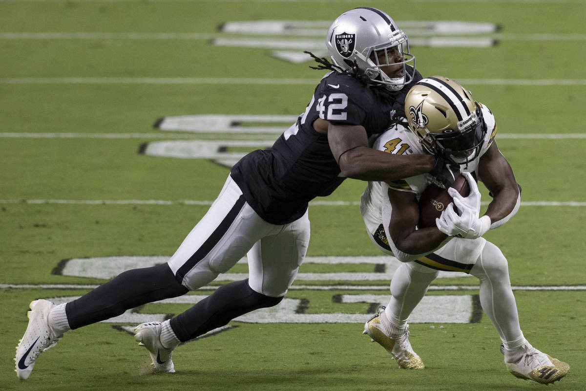 Las Vegas Raiders inside linebacker Cory Littleton (42) tackles New Orleans Saints running back ...