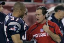 New England Patriots head coach Bill Belichick talks with Rodney Harrison during the third quar ...