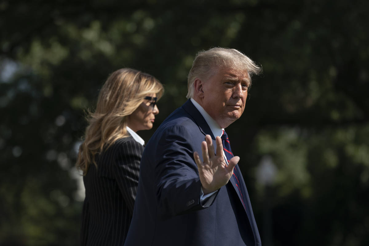 President Donald Trump and first lady Melania Trump walk to board Marine One at the White House ...