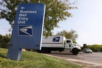 A truck departs from the U.S. Postal Service center at 1001 E. Sunset Road in Las Vegas on Thur ...