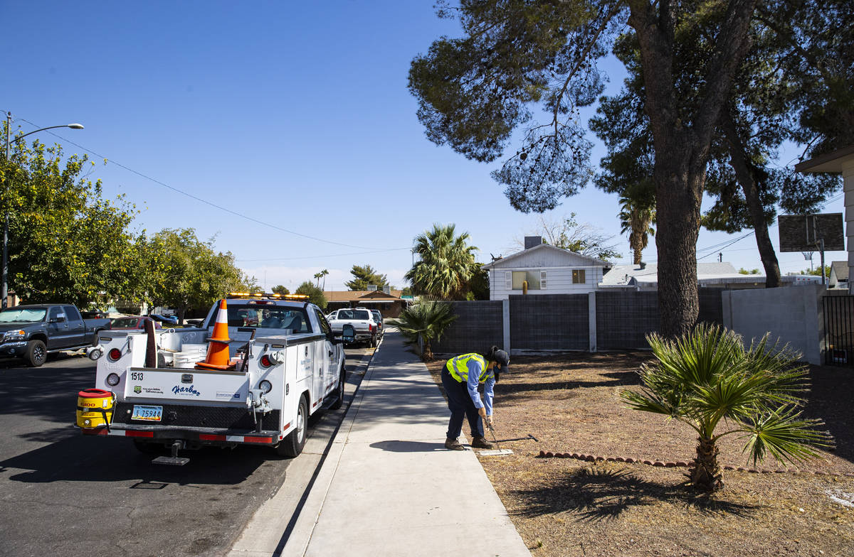 Letty Valenzuela, field technician at Las Vegas Valley Water District, checks on a water meter ...