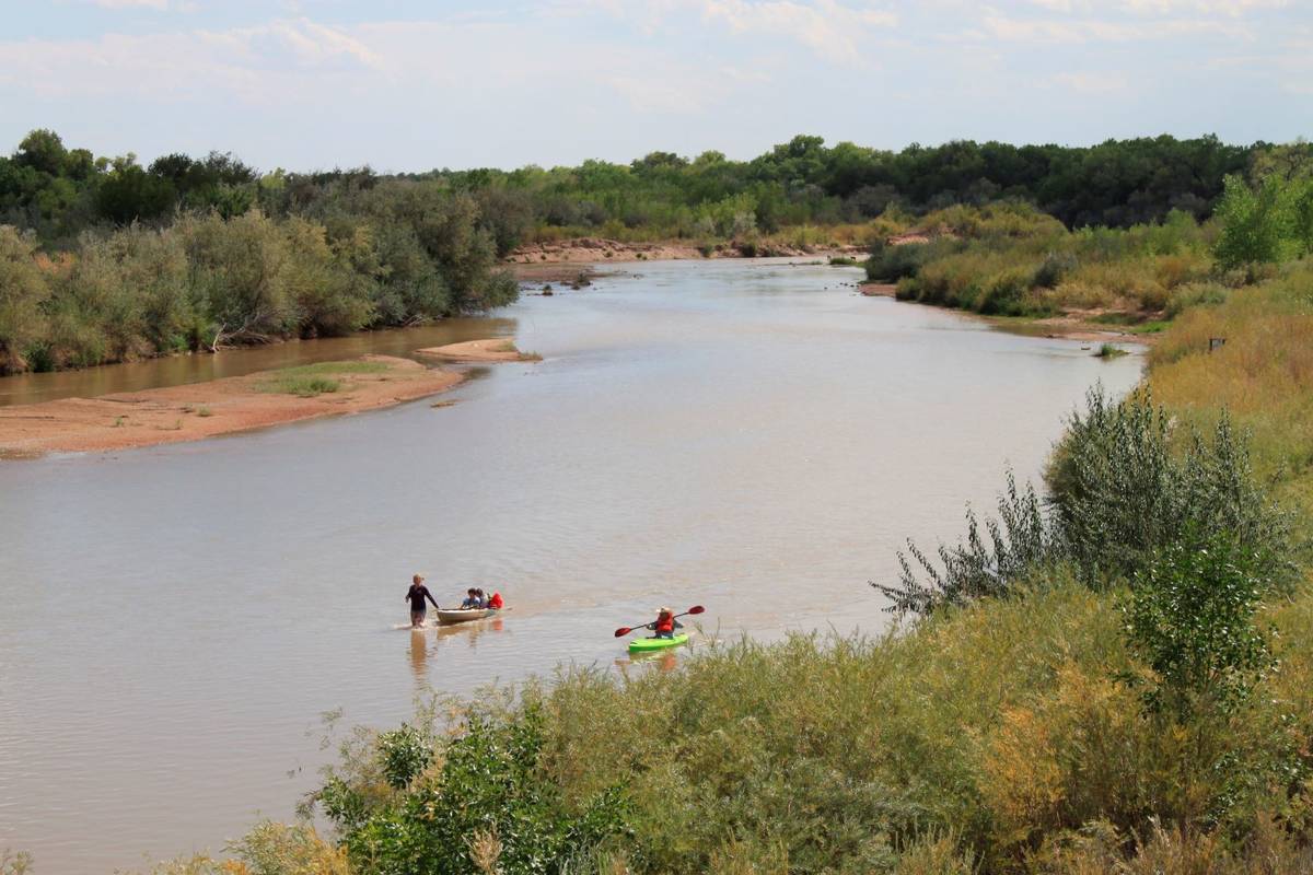 Boaters navigate the shallow Rio Grande as it flows through Rio Rancho, New Mexico, on Monday, ...