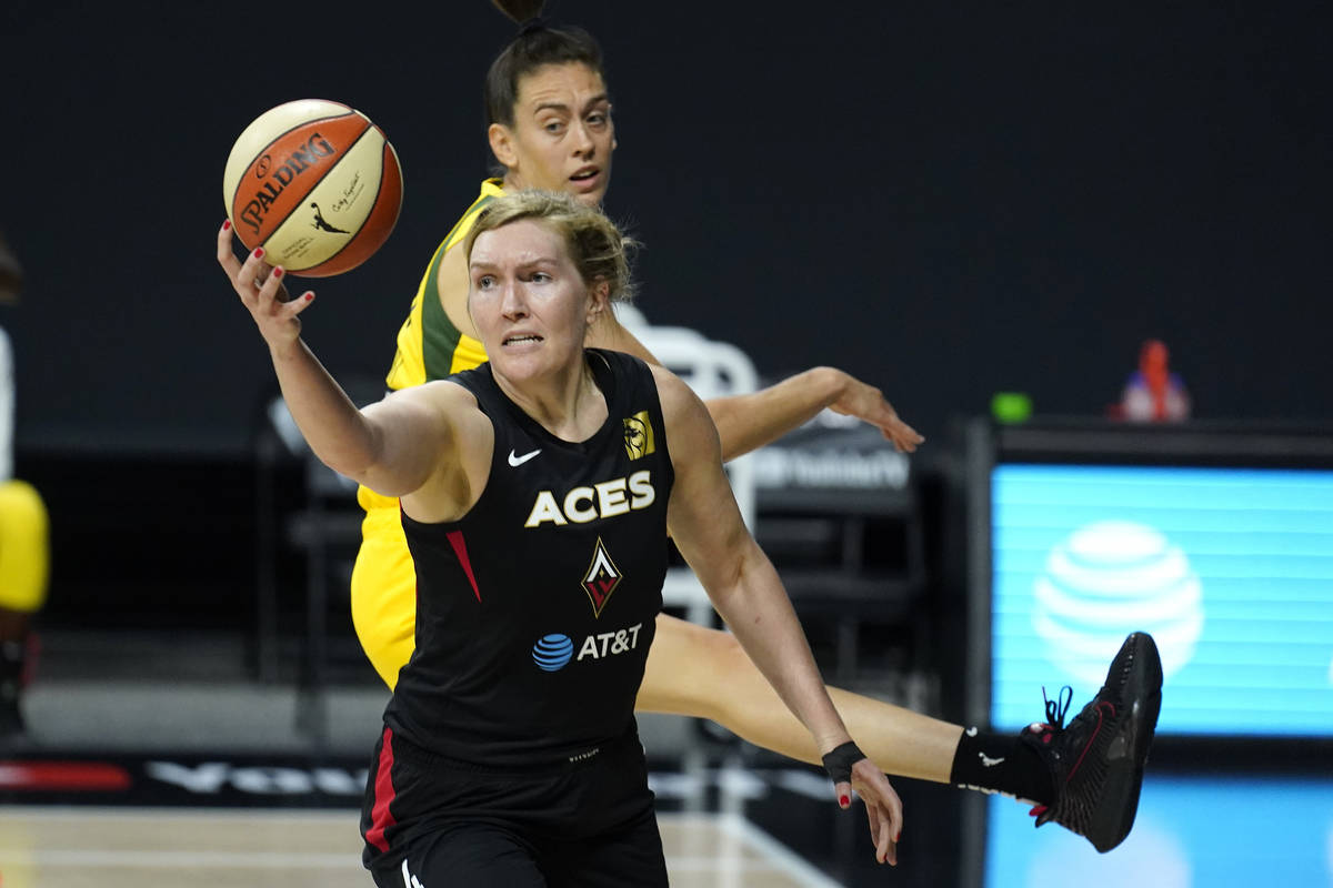 Las Vegas Aces center Carolyn Swords (4) grabs a rebound in front of Seattle Storm forward Brea ...