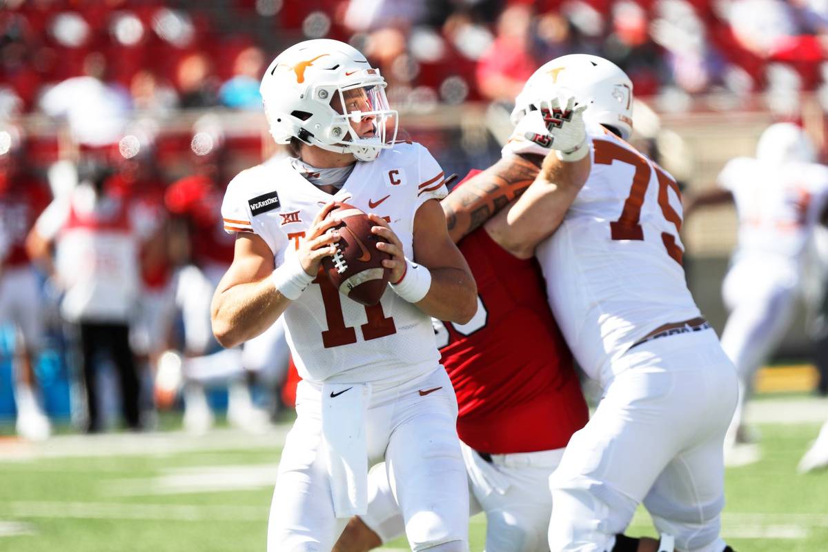 Texas quarterback Sam Ehlinger looks for an open receiver during the first half of an NCAA coll ...