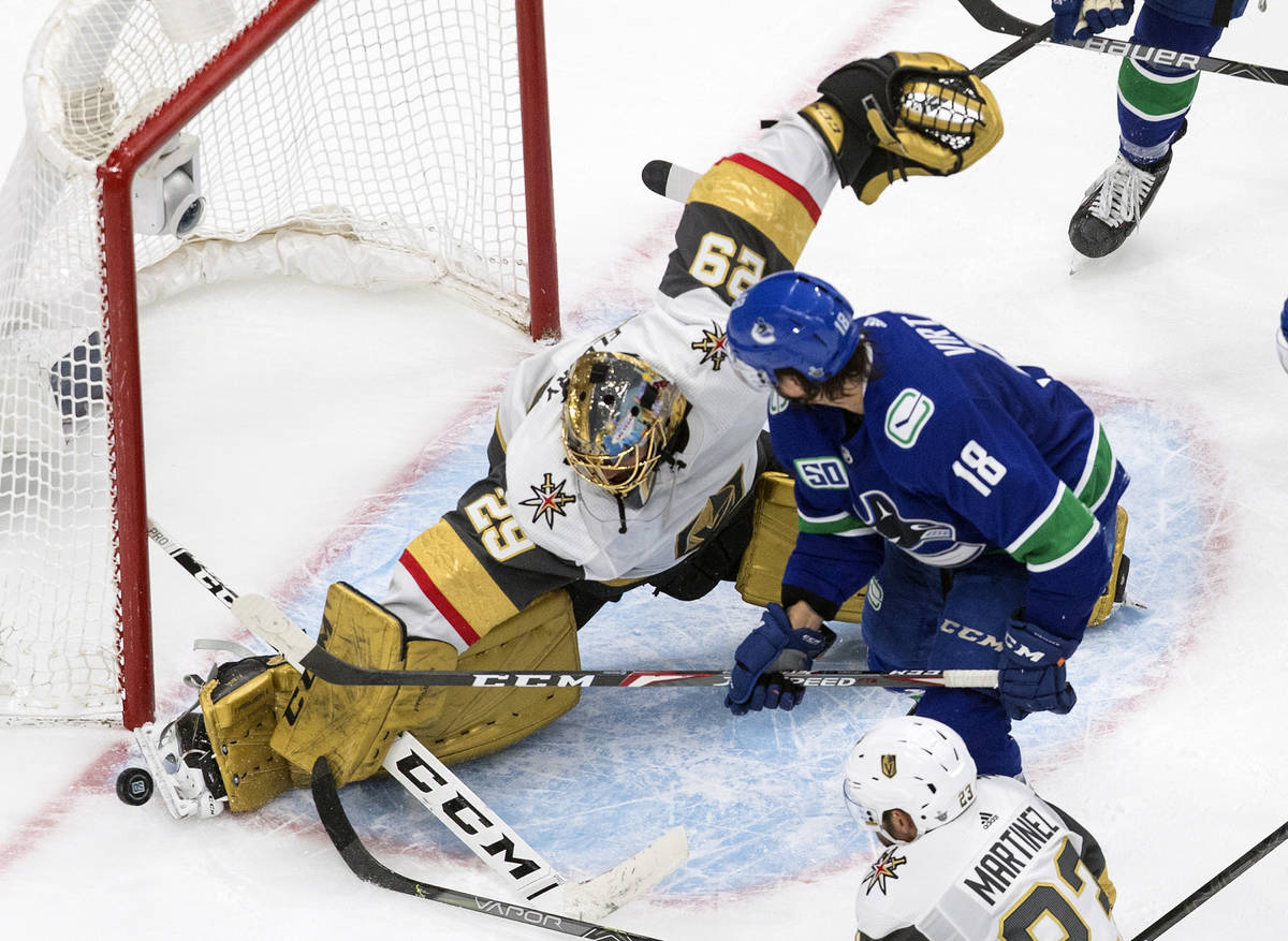 Vegas Golden Knights goalie Marc-Andre Fleury (29) makes a save on Vancouver Canucks' Jake Virt ...