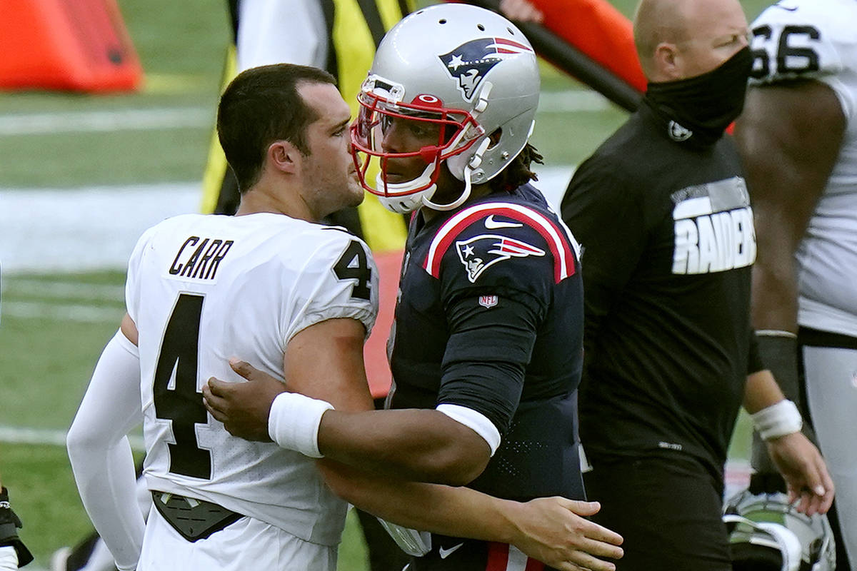 Las Vegas Raiders quarterback Derek Carr, left, and New England Patriots quarterback Cam Newton ...