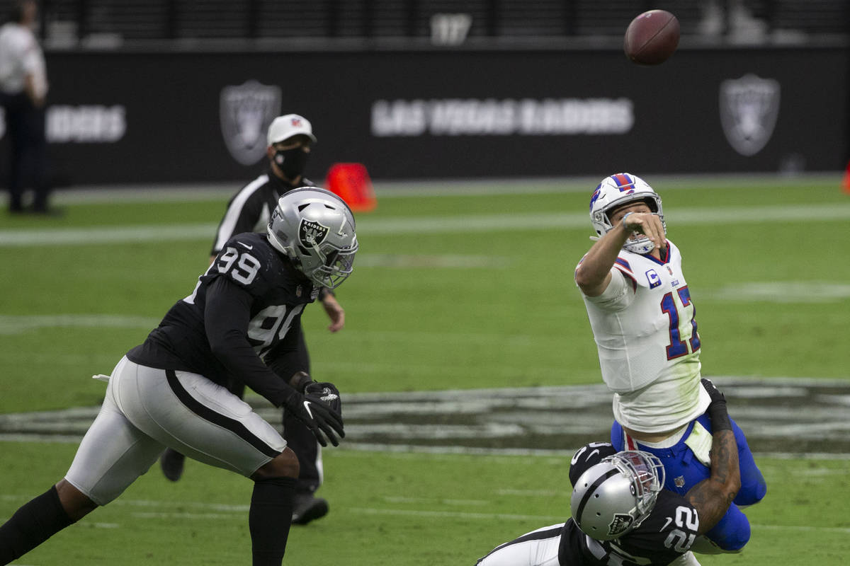 Buffalo Bills quarterback Josh Allen (17) throws as Las Vegas Raiders cornerback Keisean Nixon ...
