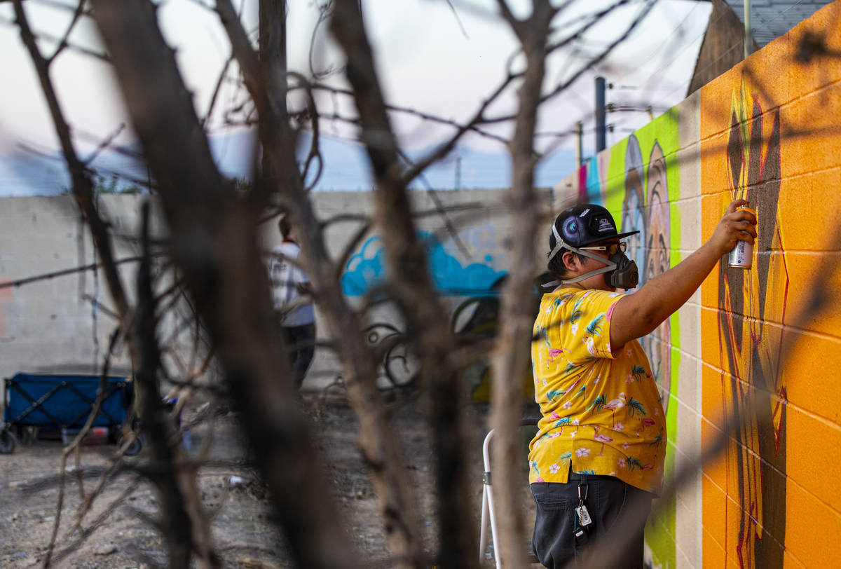 Artist Daizu, of Henderson, work on a mural at the site of the former Moulin Rouge in Las Vegas ...