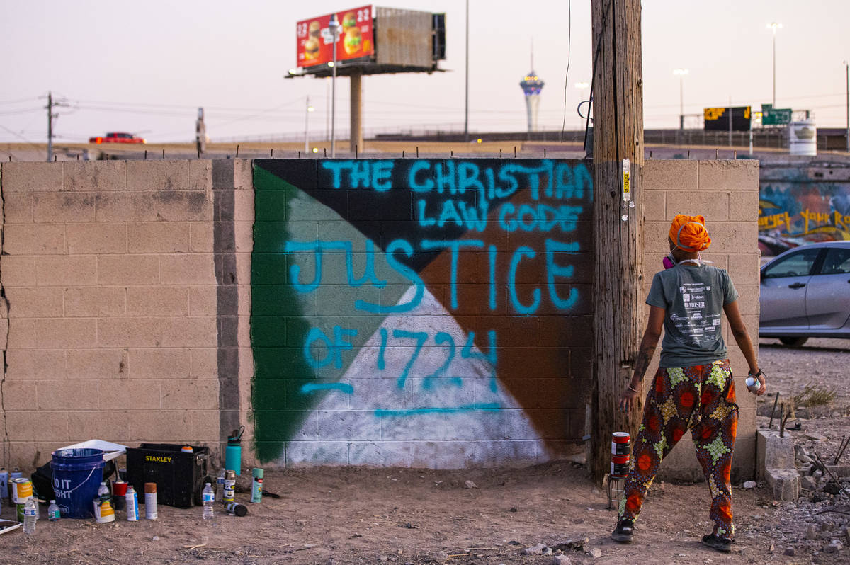 Ra'Iysa Rice takes a look at her mural as she works on it at the site of the former Moulin Roug ...