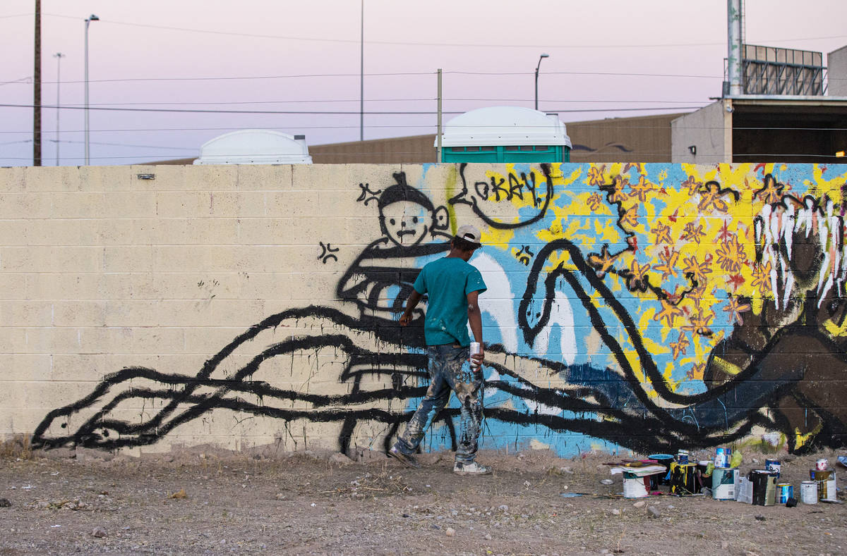 An artist who goes by Five Fs work on a mural at the site of the former Moulin Rouge in Las Veg ...