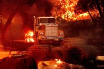 Flames from the Glass Fire burn a truck in a Calistoga, Calif., vineyard Thursday, Oct. 1, 2020 ...