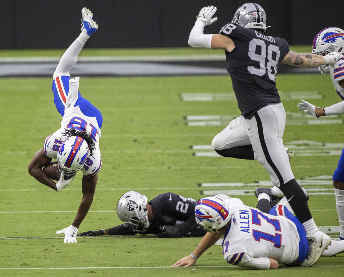 Buffalo Bills wide receiver Andre Roberts (18) is tripped up by Las Vegas Raiders strong safety ...