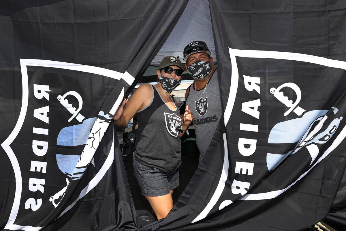 Maria Morales, left, and her husband Lorenzo Morales pose during a tailgate before an NFL footb ...