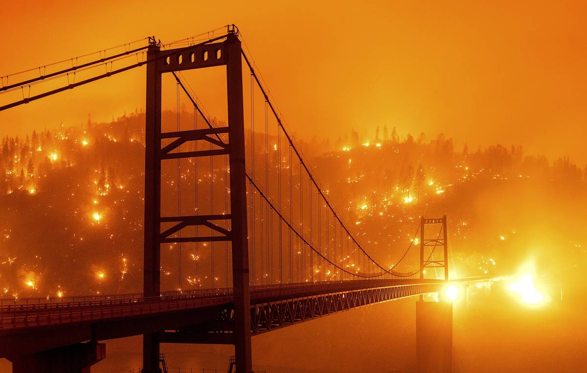 FILE - In this Sept. 9, 2020, file image taken with a slow shutter speed, embers light up a hil ...