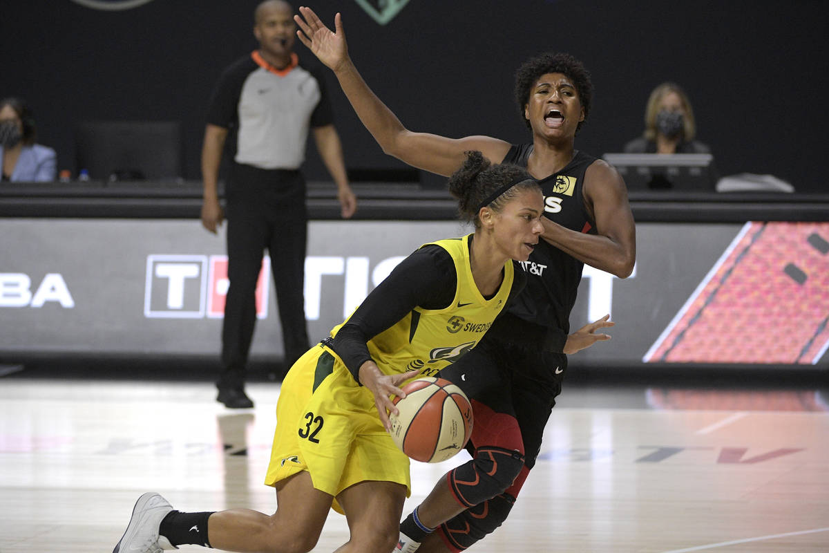 Seattle Storm forward Alysha Clark (32) is fouled by Las Vegas Aces forward Angel McCoughtry wh ...