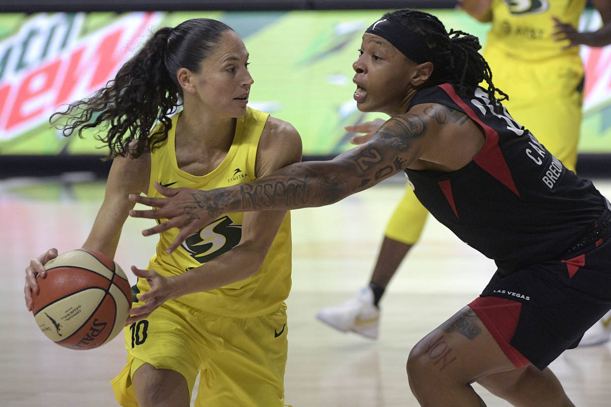 Seattle Storm guard Sue Bird (10) is defended by Las Vegas Aces forward Emma Cannon (32) during ...