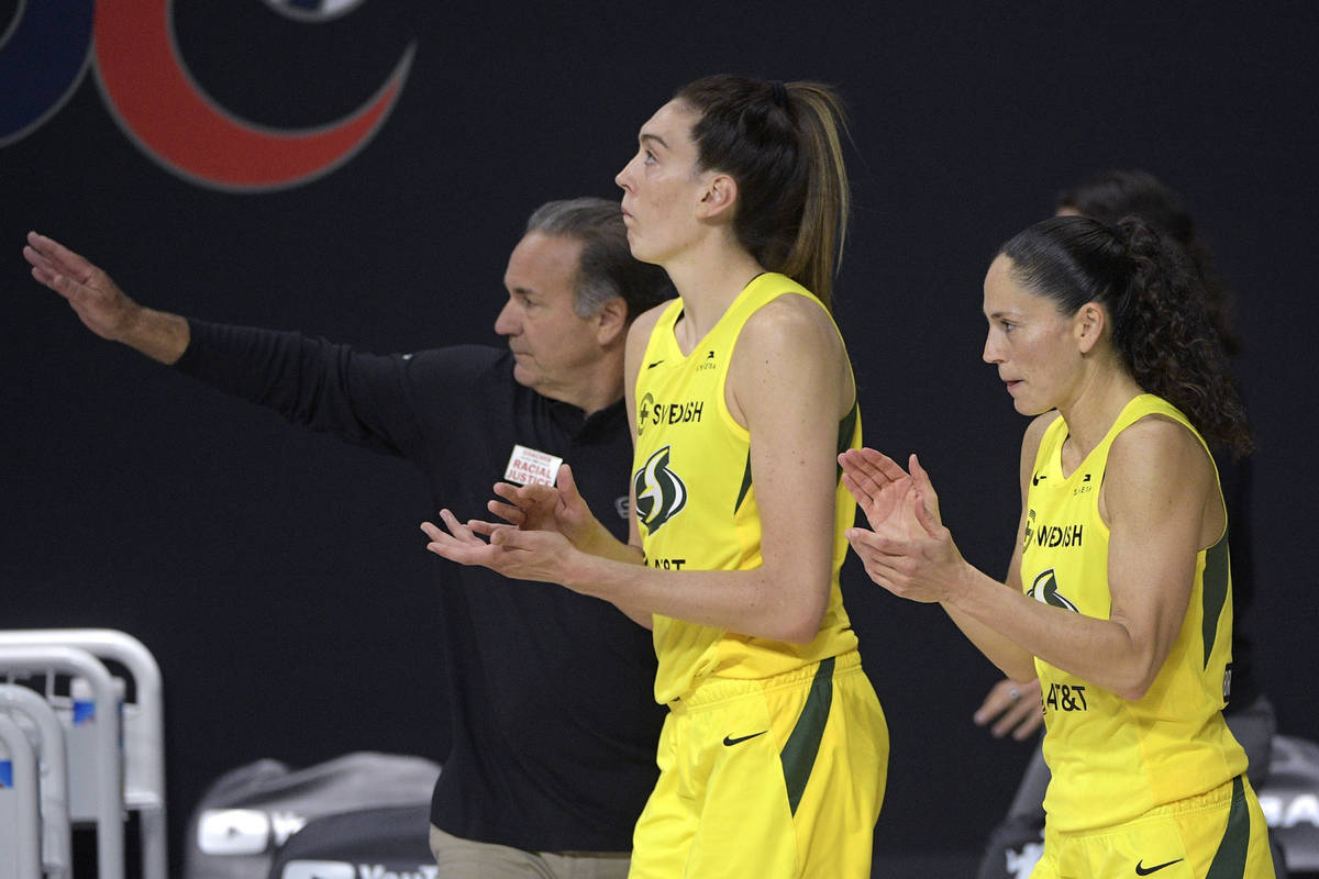 Seattle Storm forward Breanna Stewart, front left, and guard Sue Bird, right, applaud as head c ...