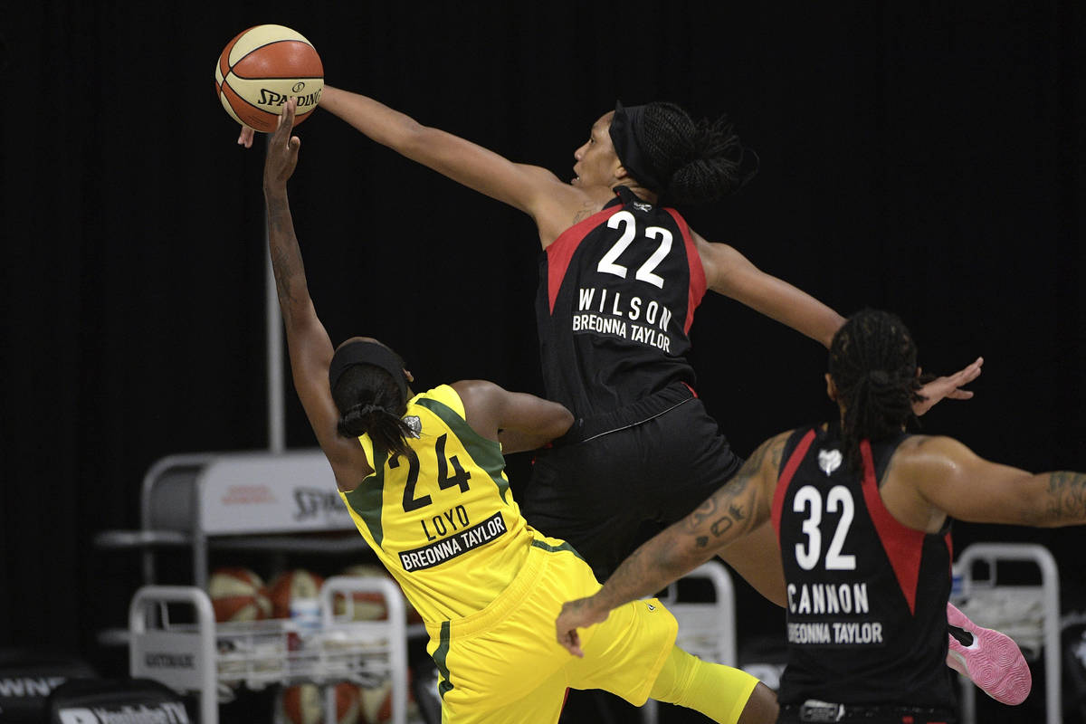 Las Vegas Aces center A'ja Wilson (22) blocks a shot by Seattle Storm guard Jewell Loyd (24) as ...