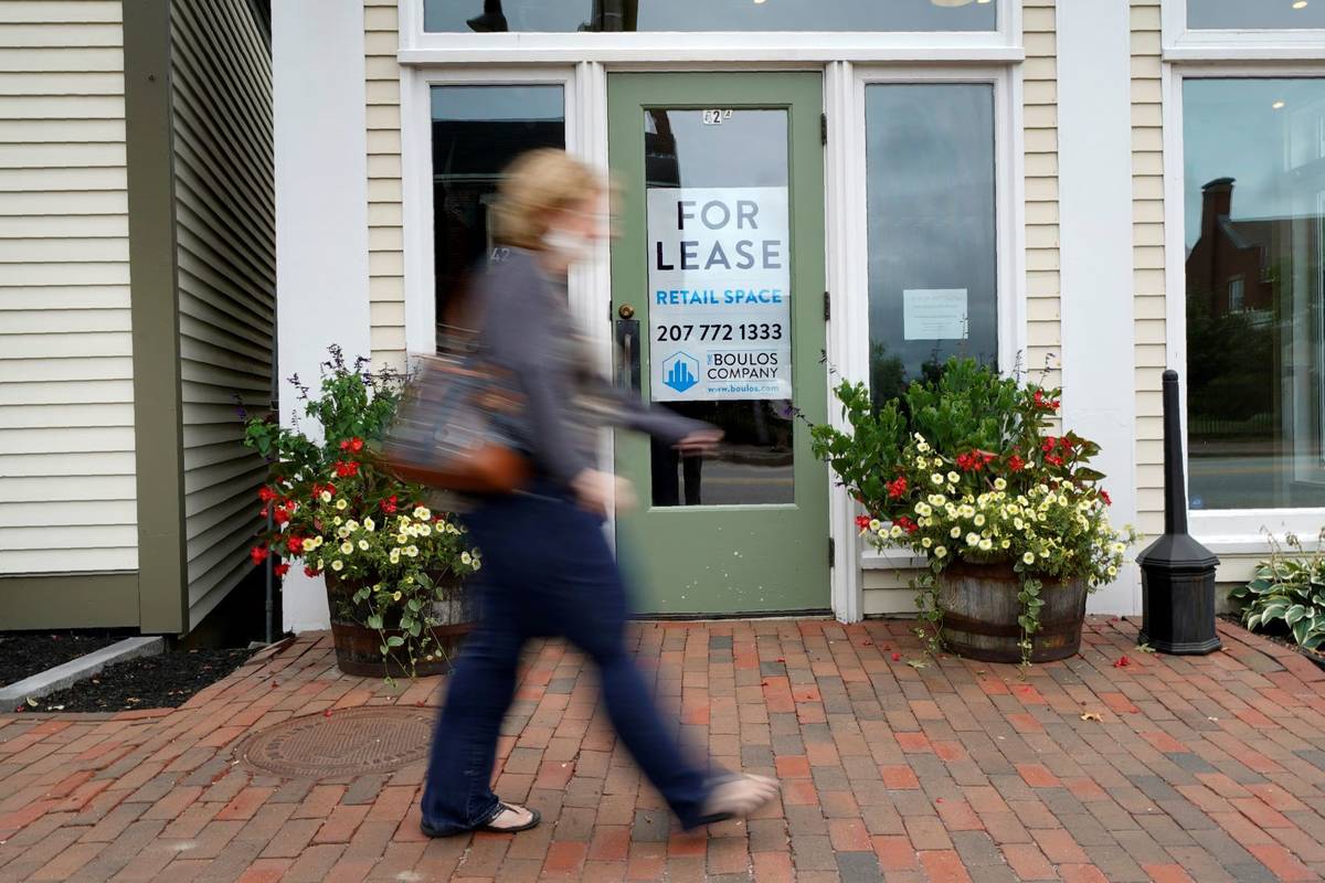 A shopper walks by one of several vacant retail spaces among the outlet shops in Freeport, Main ...