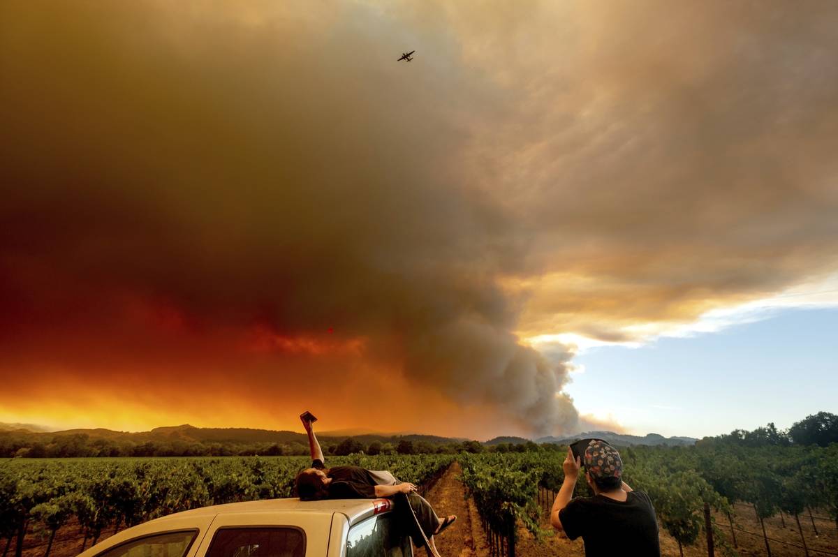 In this Thursday, Aug. 20, 2020, file photo, Thomas Henney, left, and Charles Chavira watch a p ...