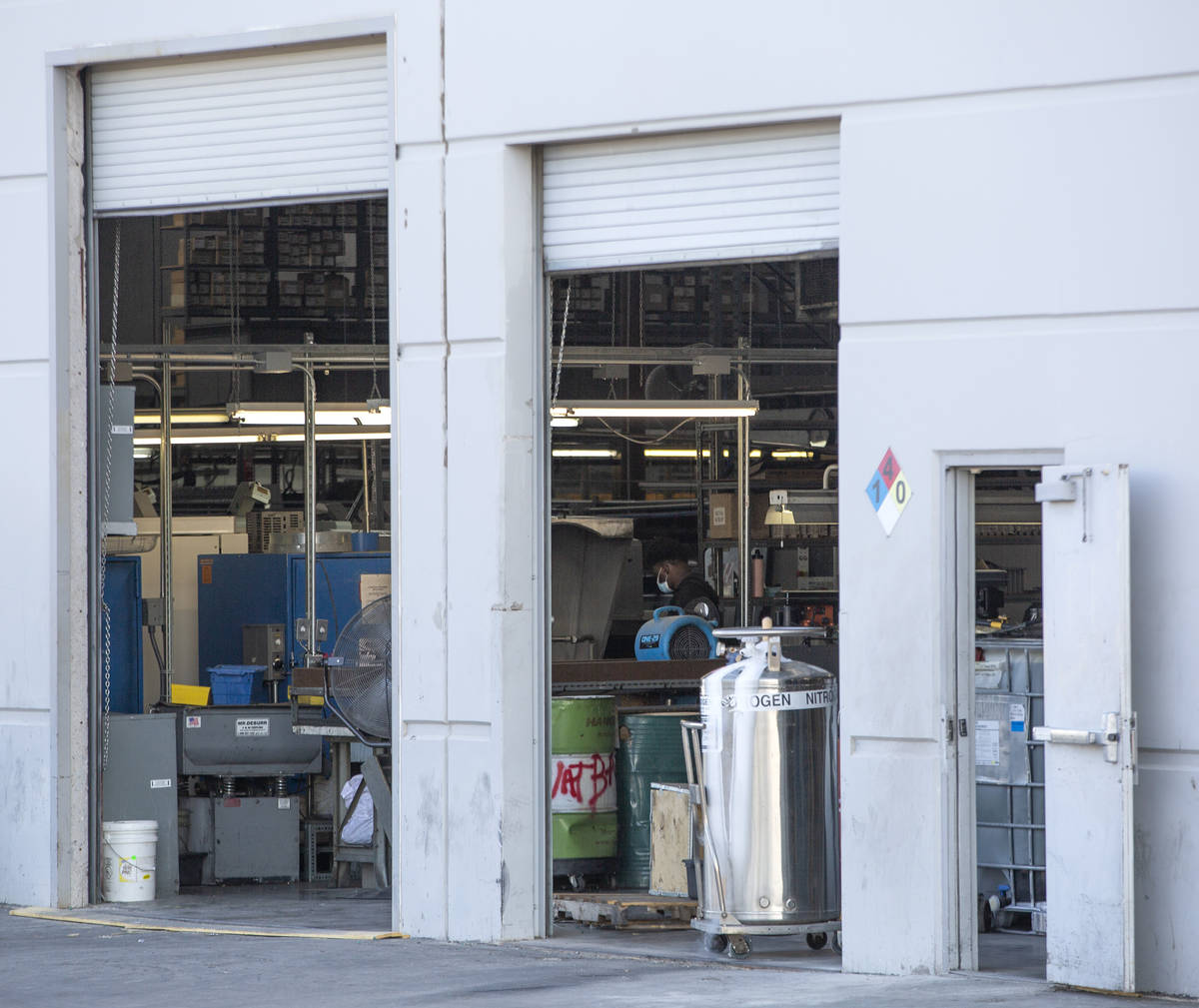 A masked employee works inside Spacecraft Components Corp. on Tuesday, Oct. 6, 2020, in Las Veg ...