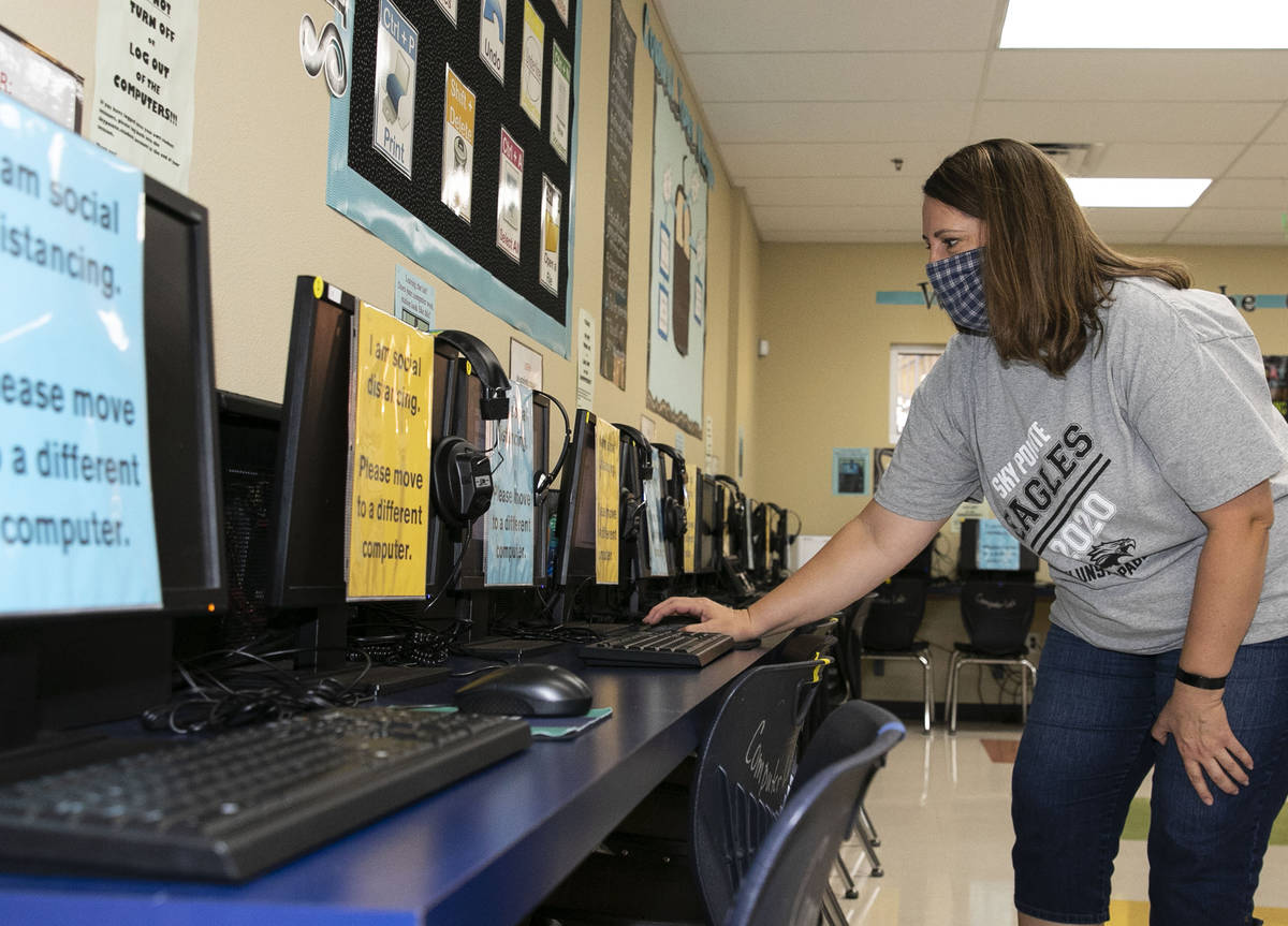 Jackie Justice, technology specialist, checks out computers at Somerset Academy Sky Pointe as s ...