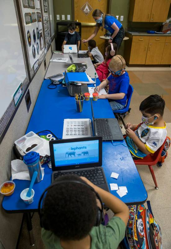 Kindergarten instructor Abby Armijo, top right, works with Bentley Breland,top left, and Nah-Ce ...