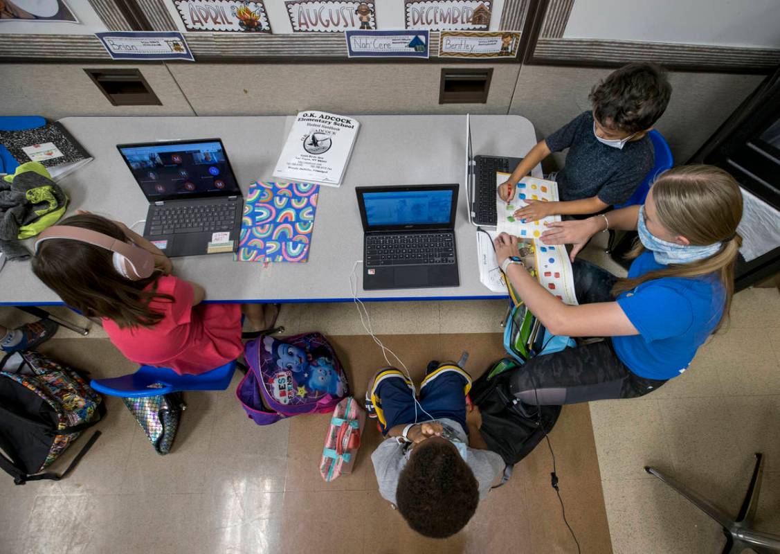 (From right) Kindergarten instructor Abby Armijo works with Bentley Breland with Nah-Cere Hibbl ...
