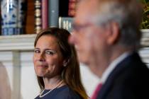 Supreme Court nominee Judge Amy Coney Barrett looks over to Senate Majority Leader Mitch McConn ...