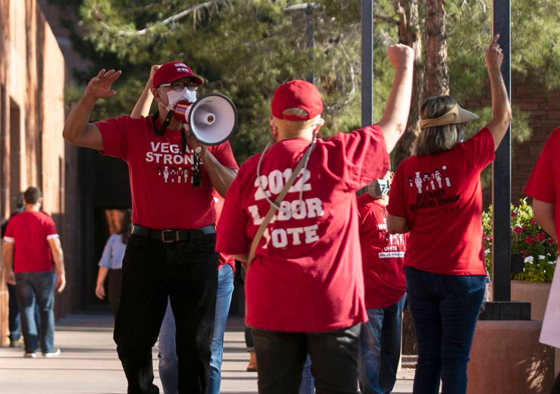 Jose Rivera, left, rally organizer, shouts slogans as he joins a rally outside of the Clark Co ...