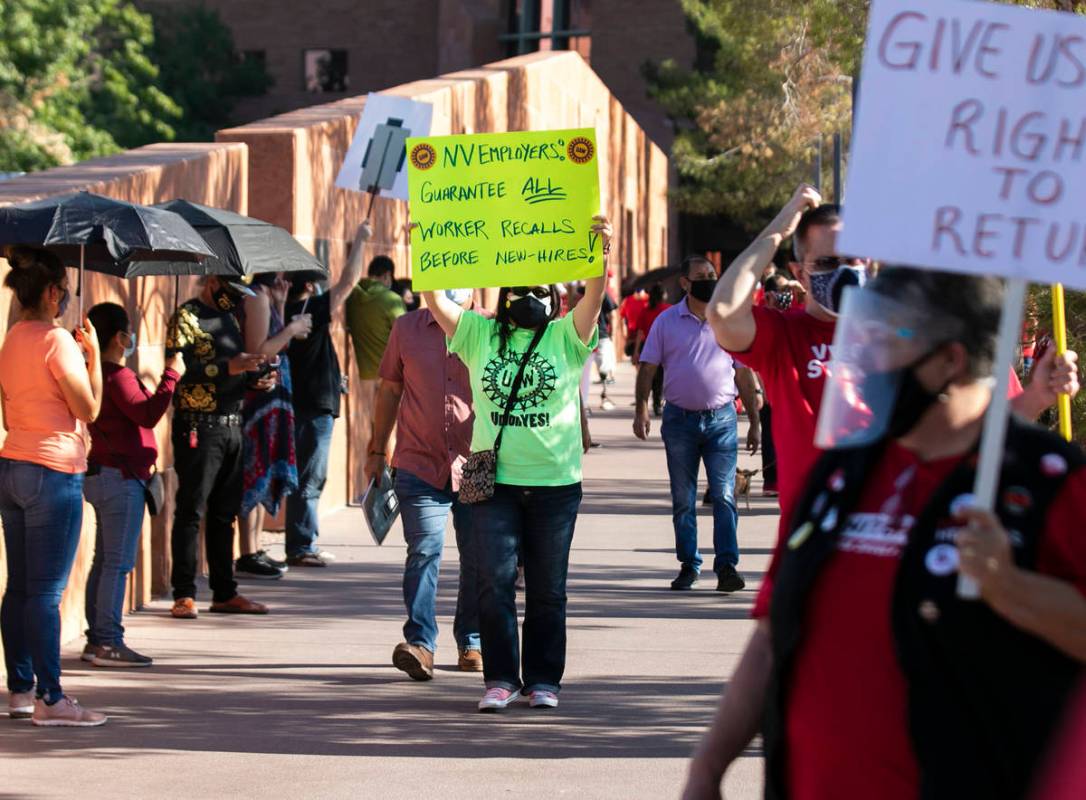 Vanessa Peck, a member of Local 631, holds a sign as she joins a rally outside of the Clark Cou ...